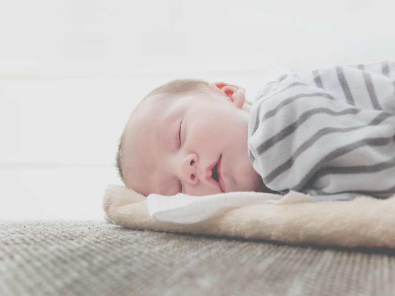 How to fix baby sleep regression - baby asleep on thin blanket on the floor
