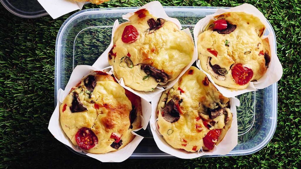 Four vegetable muffins in a clear plastic container